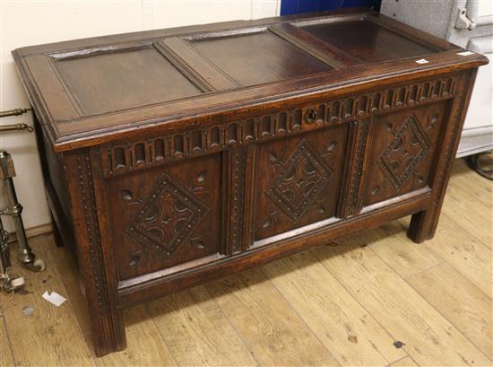 An early 18th century carved and paneled oak coffer, W.125cm